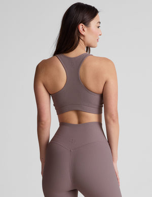 brown medium support racerback bra with a scoop neckline​, overlapping hemband detail​, is lined with performance lining and powermesh in between​, and has removable bra pads​. 