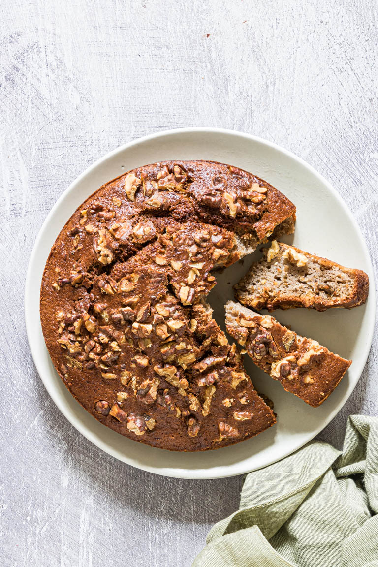 the finished banana bread loaf with two slices cut