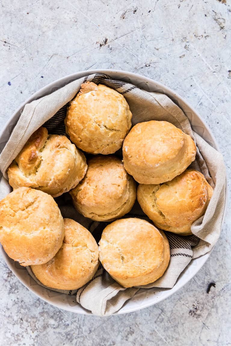 a basket containing several lemon scones on top of towels