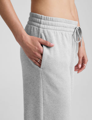 grey mid-rise wide leg sweatpants with side slits and a drawcord at waistband. 