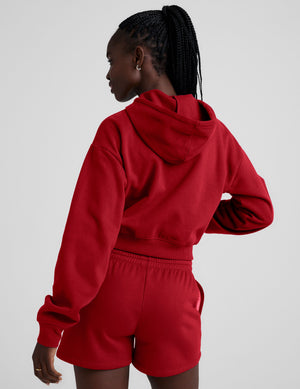 red fleece zip-up jacket with a drawstring hood. 
