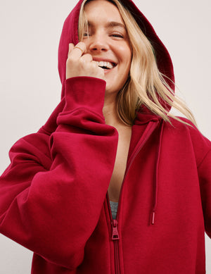 red fleece zip-up jacket with a drawstring hood. 