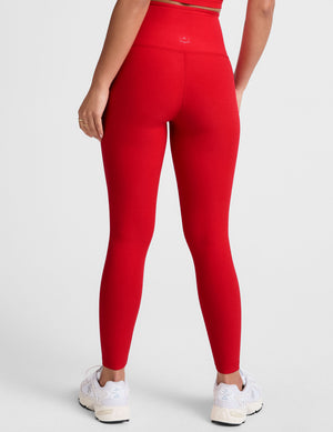 red high-waisted midi legging with criss cross front detail.