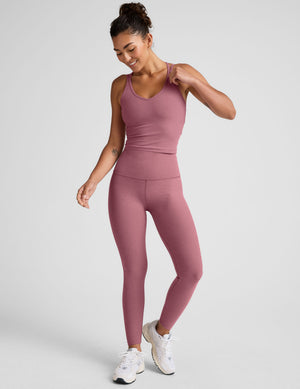 pink v-neck tank top with criss cross back straps. 