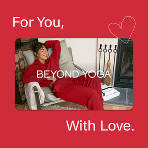 Woman in red outfit sitting on a couch with 'Beyond Yoga' branding and text on a red background.